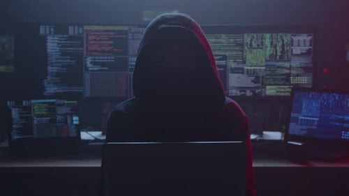 Hooded Figure Typing Code in Dark Room