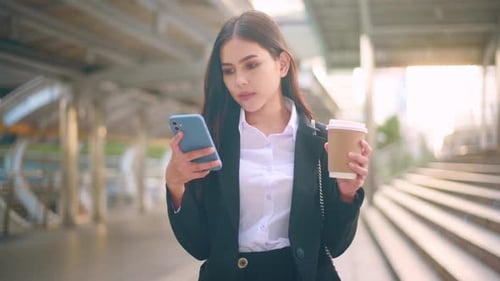 Business Woman Using Cellphone and Drinking Coffee
