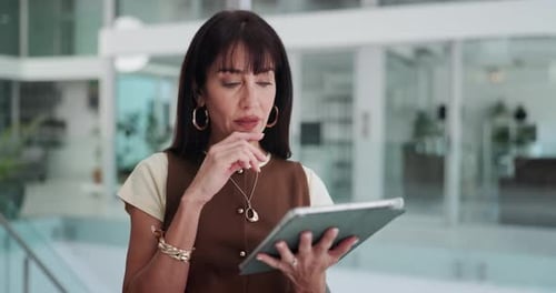 Businesswoman Using Tablet in Modern Office Lobby
