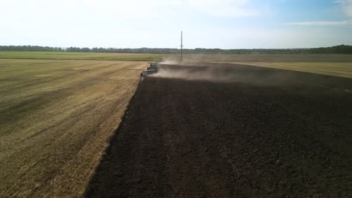 Tractors plowing the field in Ukraine