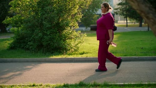 Plus Size Woman Walking with Exercise Mat