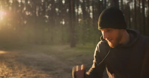Portrait of Young Man Athlete Training in the Forest Shadow Boxing on Sunrise in Nature
