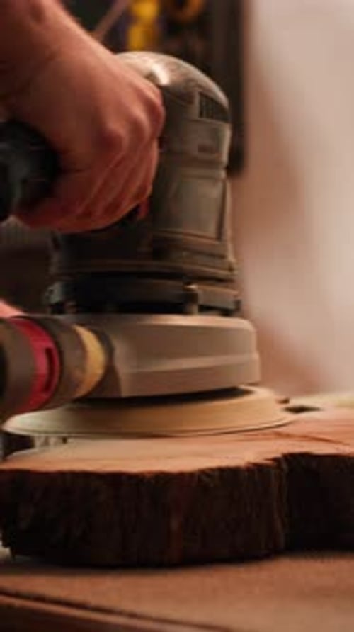 Vertical Video Woodworking Specialist Uses Angle Grinder on Wood Close Up Shot