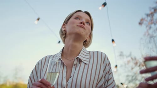 Young Adults Chatting and Drinking Champagne