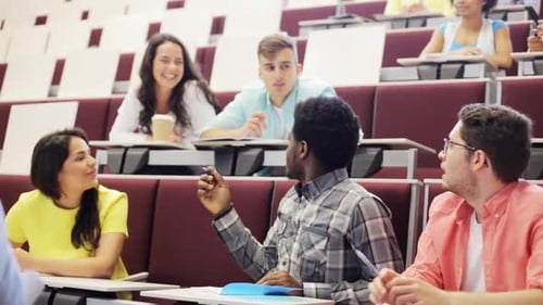 Group of International Students with Notebooks Sitting in Lecture Hall and Talking African