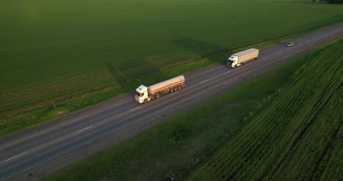 A Truck is Moving Along the Road at Sunset Aerial View