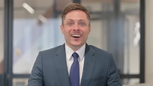 Businessman Reacting to Success in Office Setting