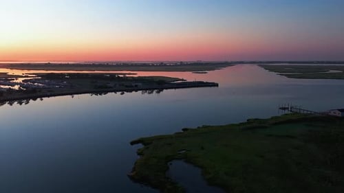 An aerial view over the salt marsh off Freeport, NY during a colorful sunrise.