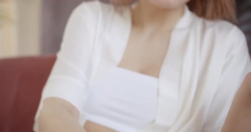 Woman Applying Serum to Hands Indoors