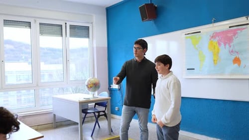 Teacher Explaining Lesson to Students in Classroom