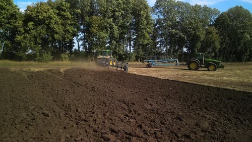 Tractors plowing the field in Ukraine
