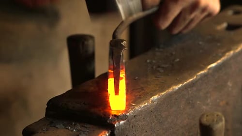 Blacksmith Forging Hot Metal on Anvil Close Up