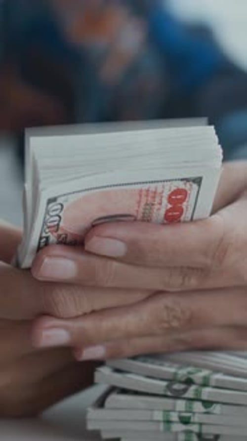 Employee Counting Banknotes Indoors