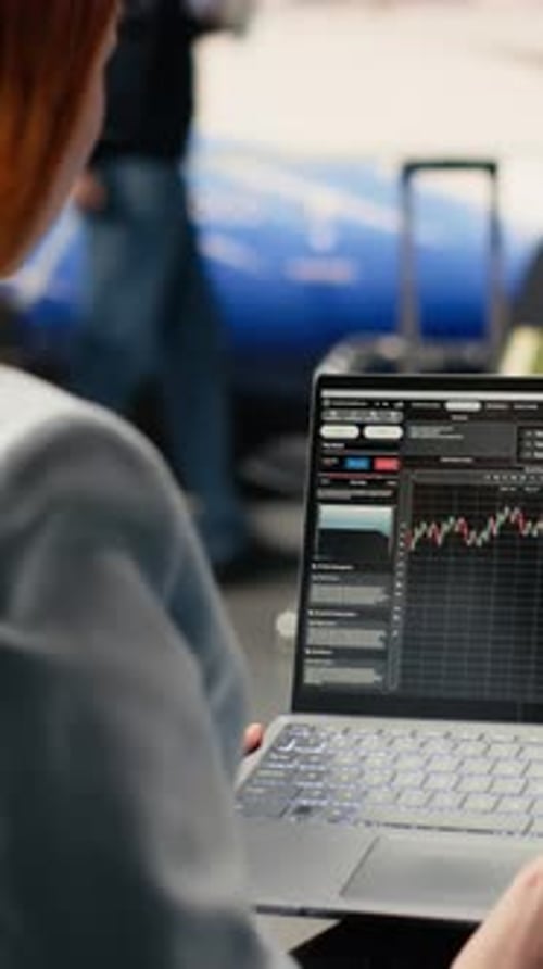 Vertical Video Digital Nomad Woman Analyzing Financial Trends and Stock Market Data
