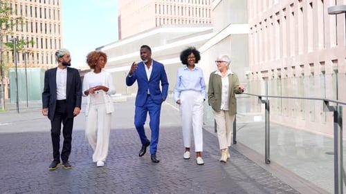 Multi-ethnic business people walking along the financial district