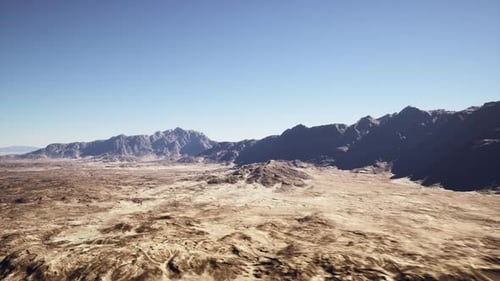 Cinematic Shot of Desolate Rocky Desert with Distant Mountains and Sky