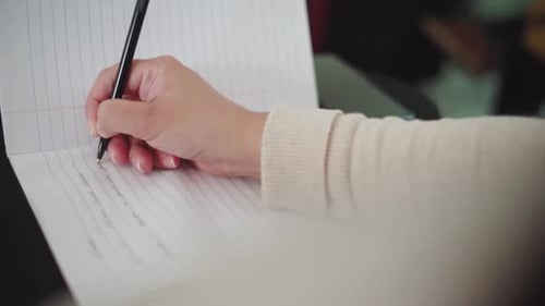 Person writing notes on paper!