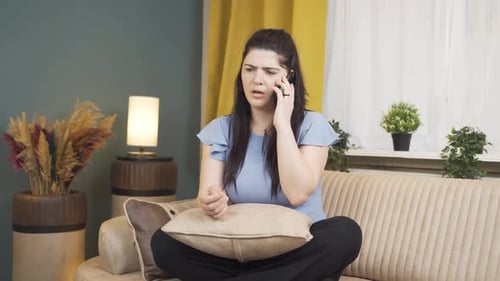 Woman Talking on Phone on Couch at Home