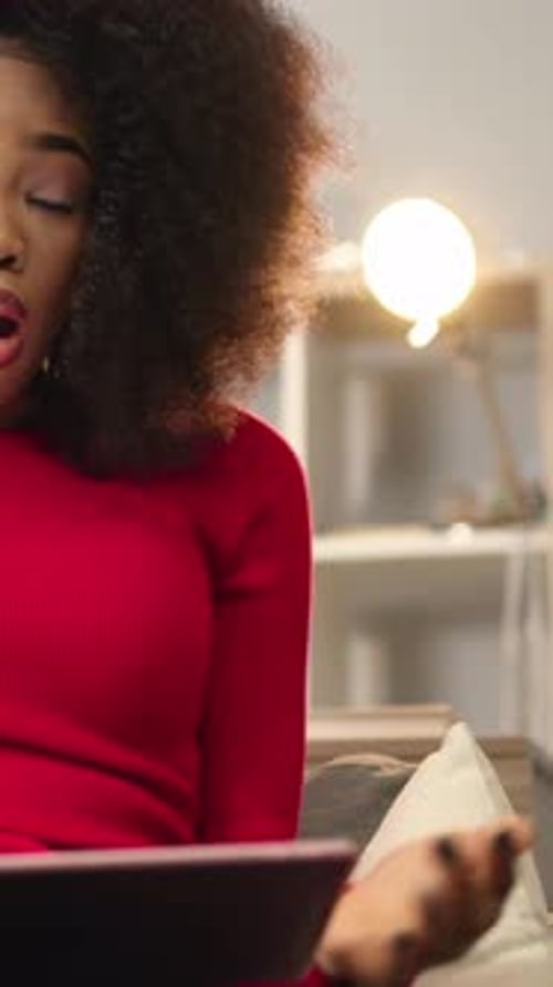 Woman Using Tablet on Sofa Indoors