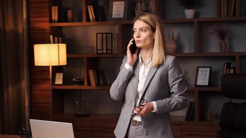Businesswoman Talking on Phone in Modern Office