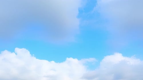 Clouds Drifting Across a Bright Blue Sky