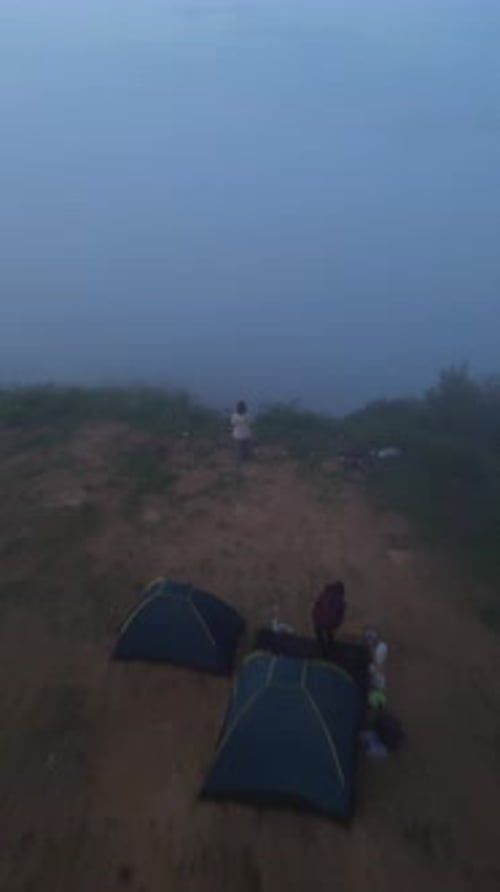 Aerial View of Mountain Climbers in the Morning Fog at the Summit of Bukit Arang, Indonesia