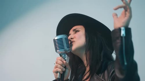 Woman Sings into Vintage Microphone in Studio