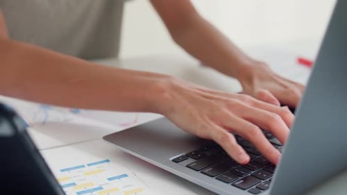 Close-up Young Asia girl IT development programmer typing on keyboard coding programming fixing data