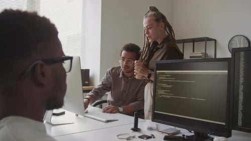 Colleagues Working on Computer Presentation in Office