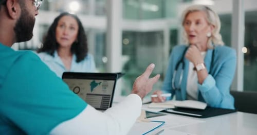 Data, healthcare and laptop with people in boardroom of hospital for meeting, planning or research