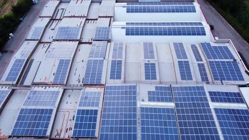 aerial view of solar panels installed on the roof of an industry. solar alternative energy concept