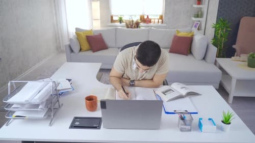 Young Adult Studying at Desk at Home