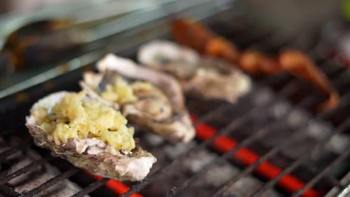 Chef Grilling Decadent Oysters With Topping