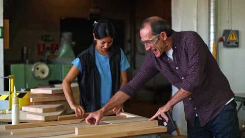 People Building Wooden Frame in Workshop Setting