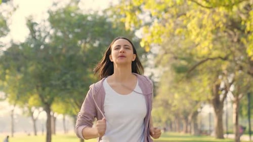 Woman Runs Toward Camera in Green Park
