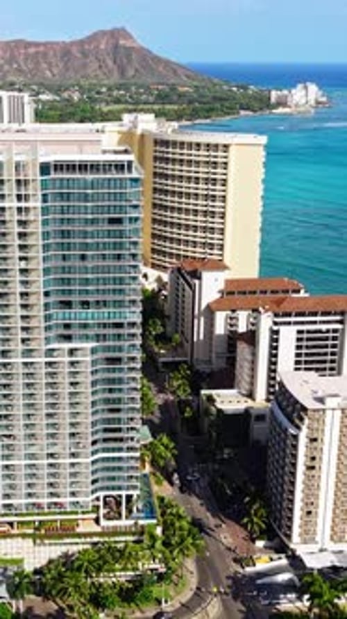 Honolulu Hawaii USA, Vertical Drone Shot of Condominium and Hotel Buildings Along Waikiki Beach