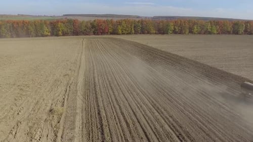 Big red tractor working on the field cultivating and applying nitrogen ASP