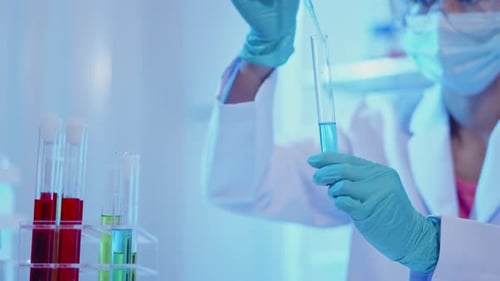 Scientist Working with Liquids in a Bright Lab