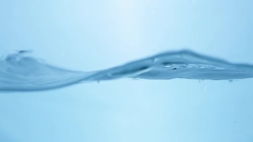 Water Surface Slow Motion Abstract Background. Bubbles rise to the surface. Fresh water waves with s