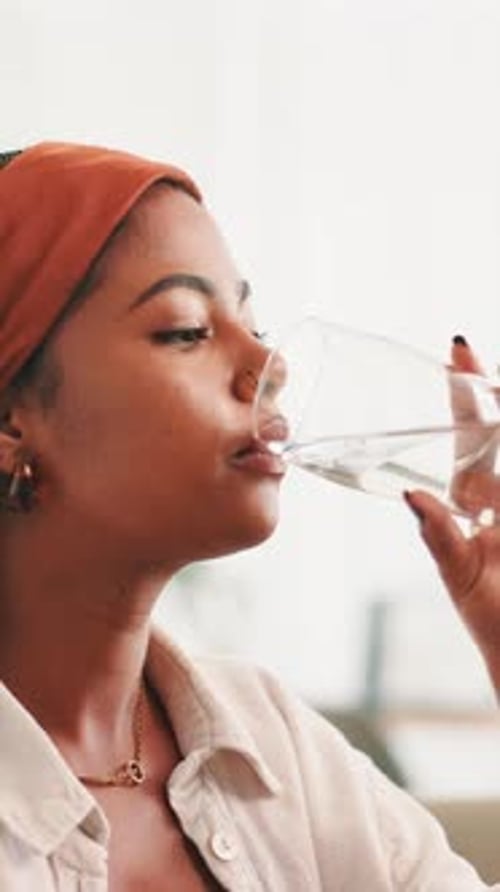 Young Woman Drinking Refreshing Water in Close-up
