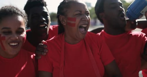 Enthusiastic Fans Cheering and Yelling at Outdoor Sporting Event