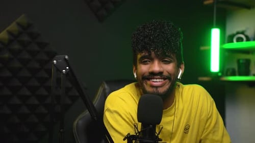 Young Adult Man Speaking Into Microphone