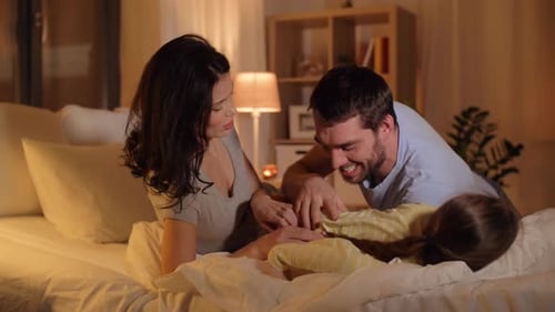 Playful family bonding together in the bedroom