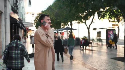 Man Talking on Phone on City Street