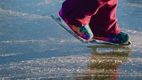 Ice Skater Glides on Frozen Lake on Sunny Day