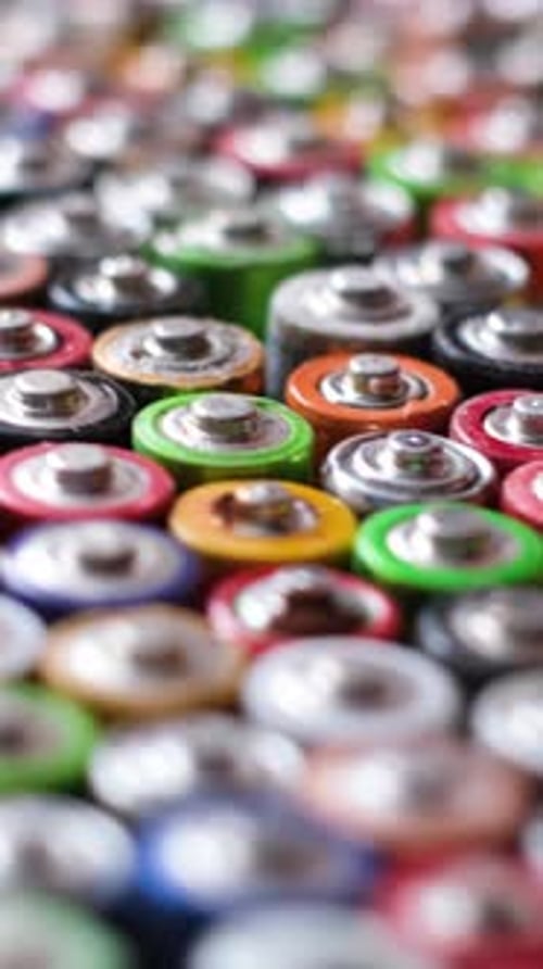 Lots of Old Used Corrosive Batteries Close Up of Positive End AA Batteries Vertical Video