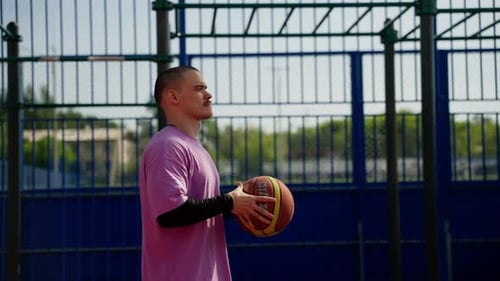 Man Spinning Basketball on Finger at Court