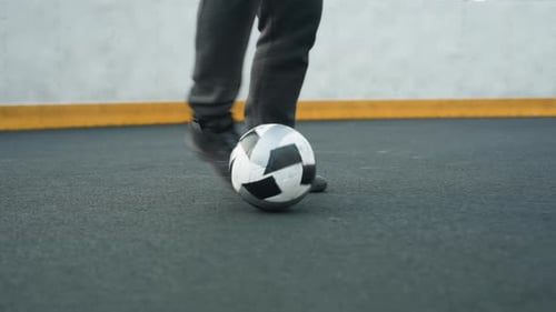 Leg View of Man Skillfully Controlling Soccer Ball on Sport Arena