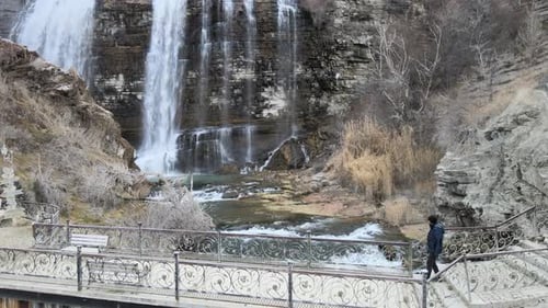 Waterfall and a person on a bridge
