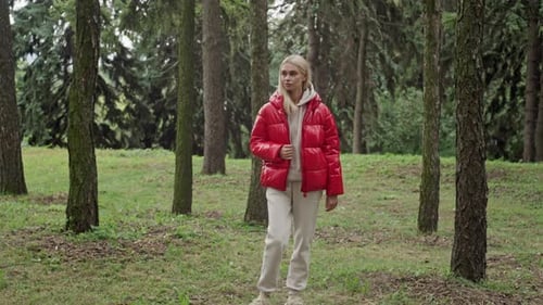 Caucasian Female Model in Tracksuit and Jacket in Forest